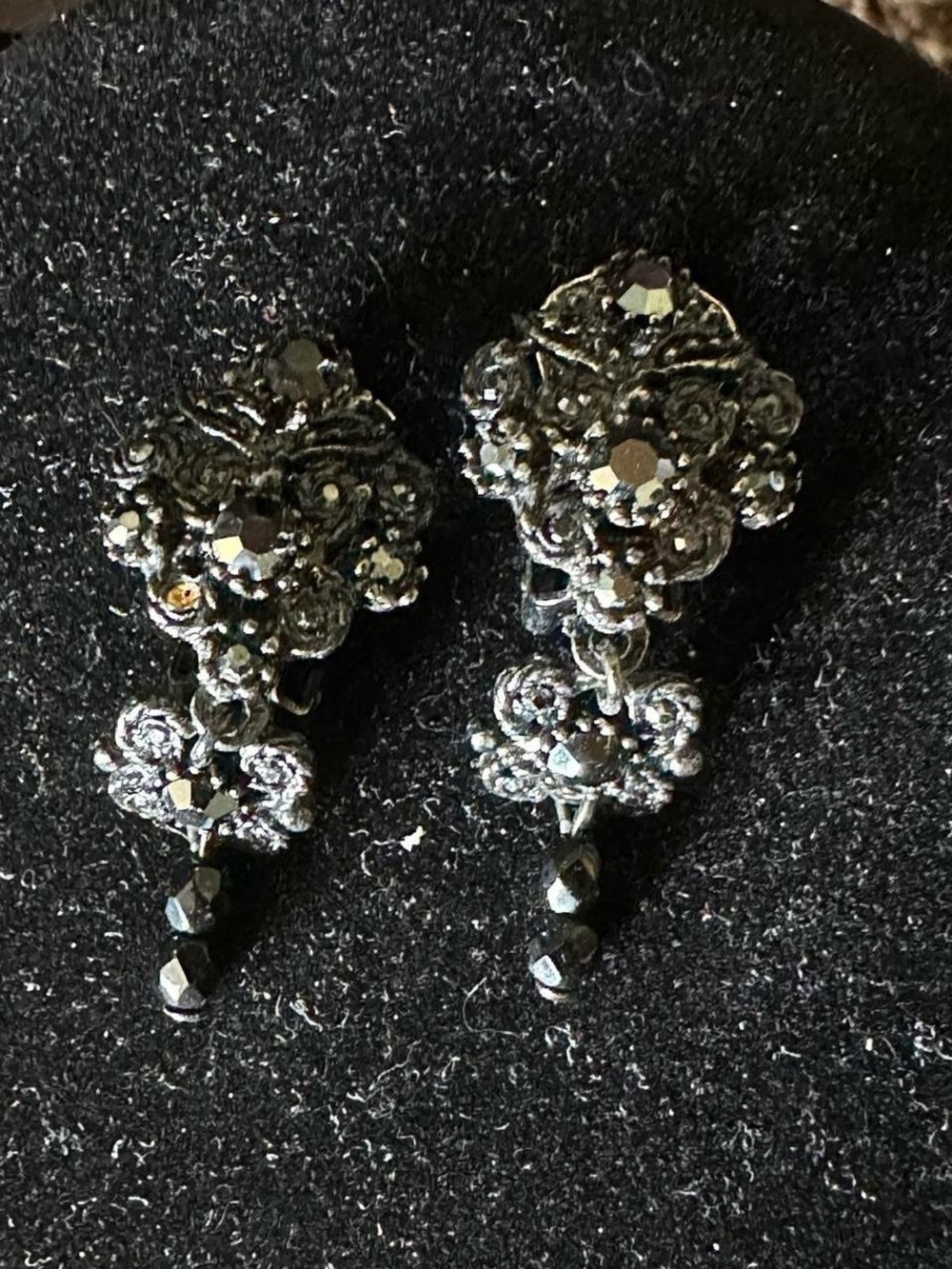 Vintage black rhinestone clip on snap earrings.